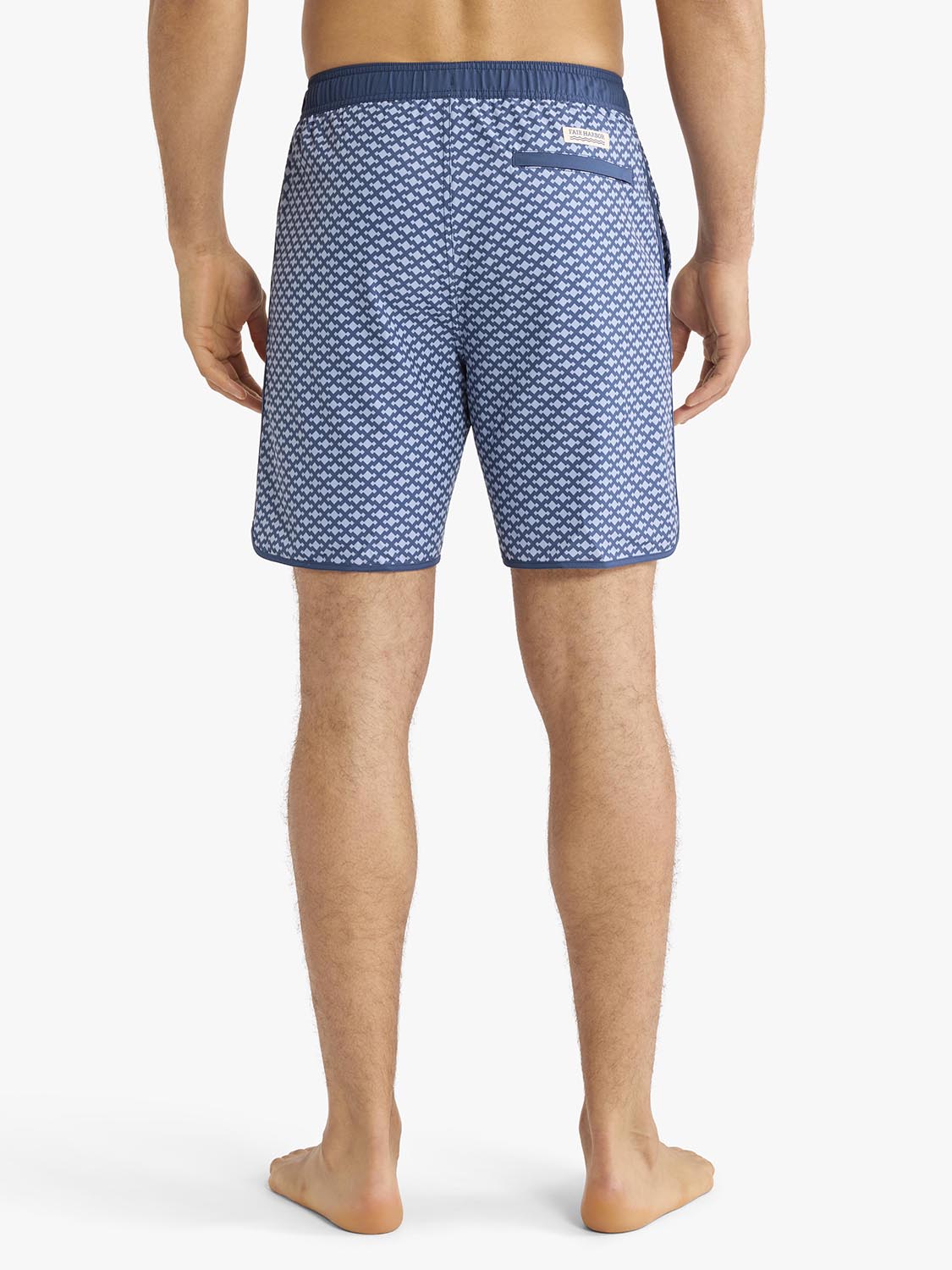Men's swim trunks with small anchor pattern in navy and light blue colorway.
