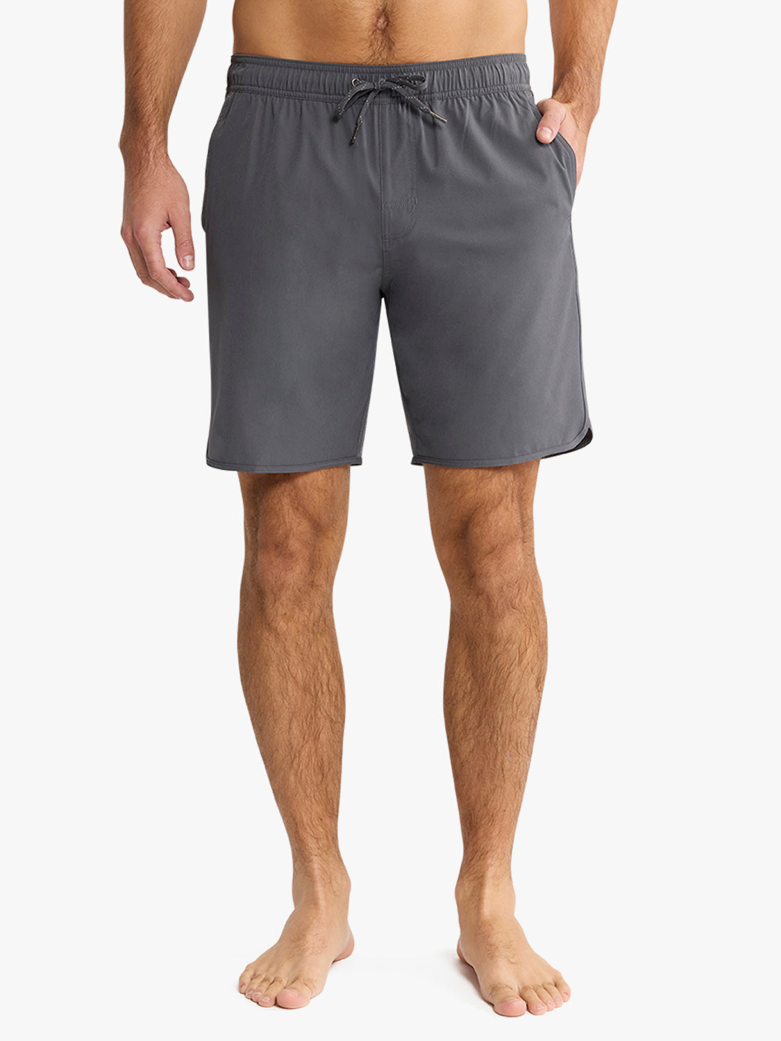 Man wearing slate gray shorts with drawstring waist and side pockets.