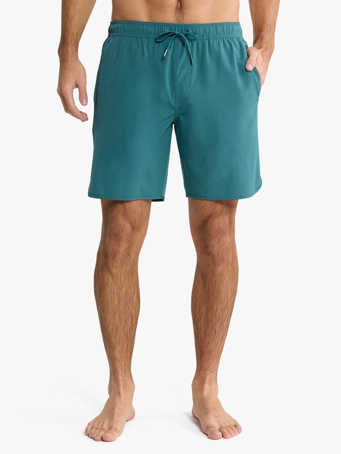 Man wearing seapine green swim shorts with drawstring waist and side pockets.