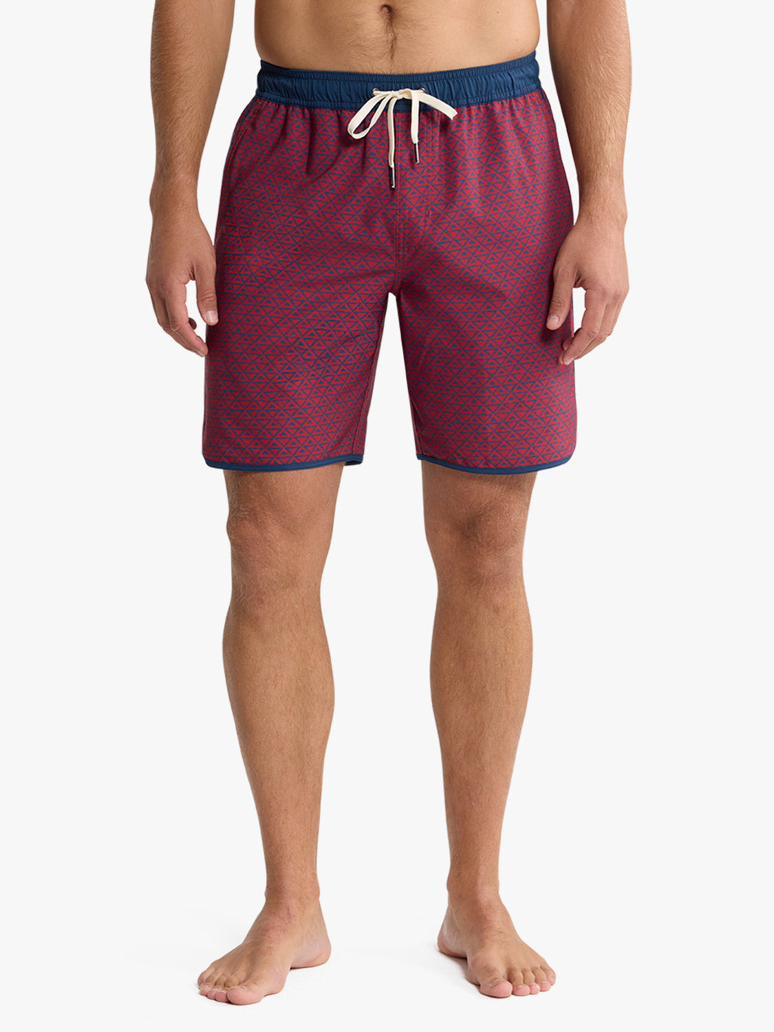 Men's swim trunk in nautical red with geometric wave pattern and navy waistband.