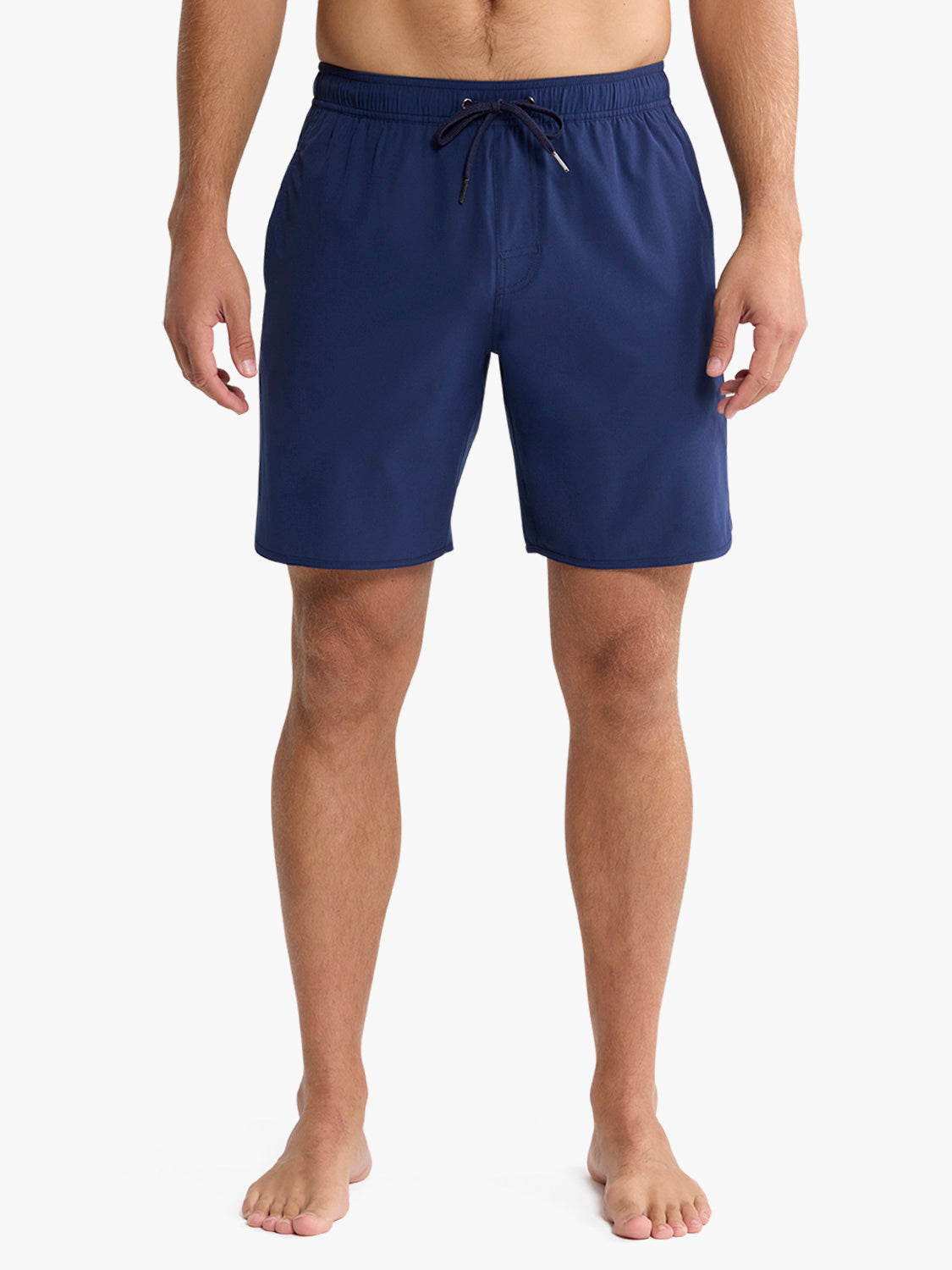 Man wearing navy blue swim shorts with drawstring waistband and side pockets.