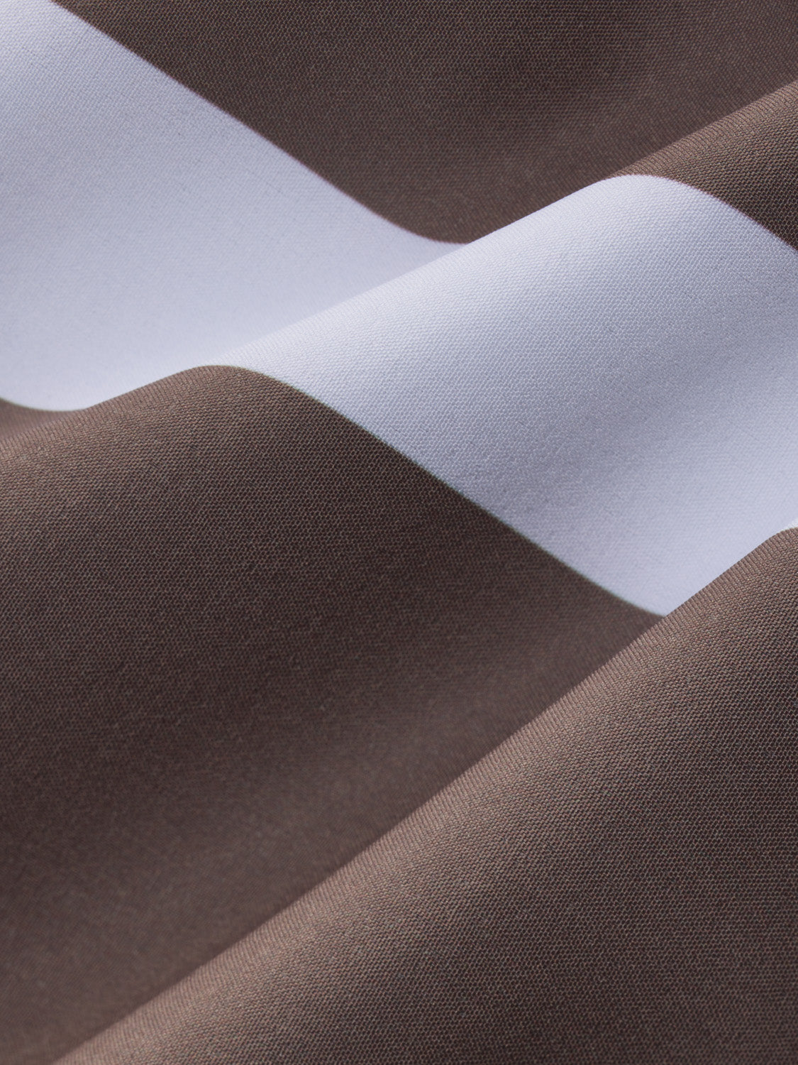 Close-up of brown and white striped fabric showing alternating horizontal bands of woven textile material.