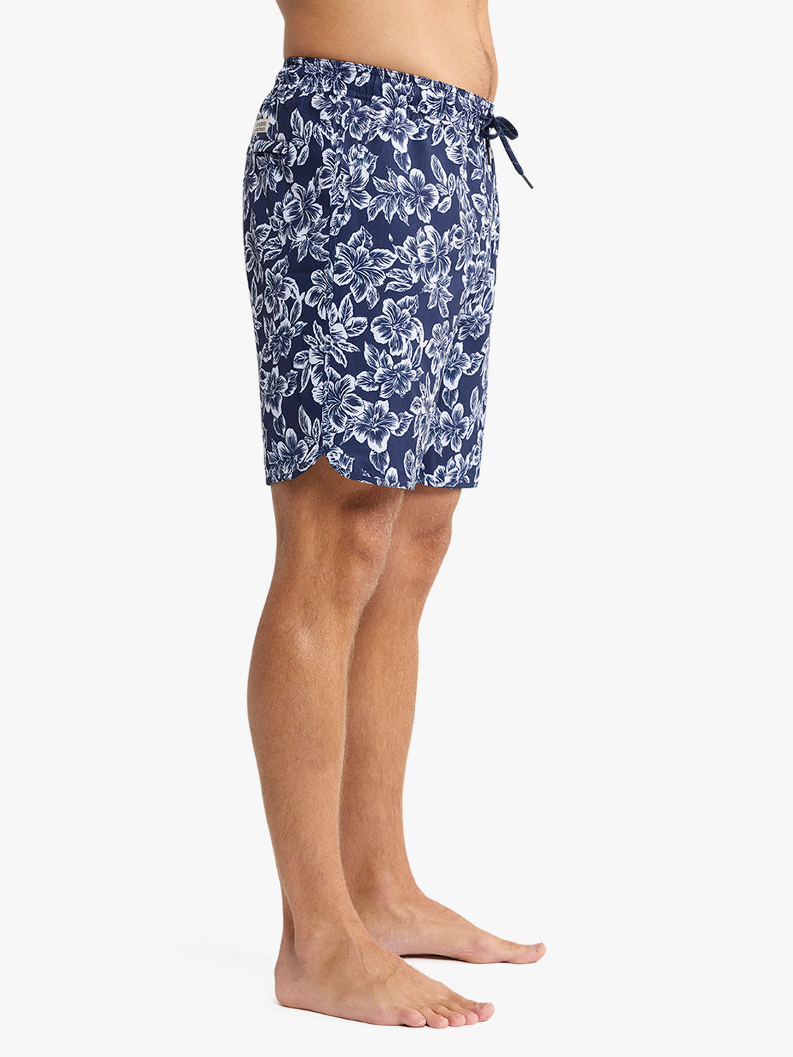 Navy swim trunks with white botanical floral print and drawstring waist closure.