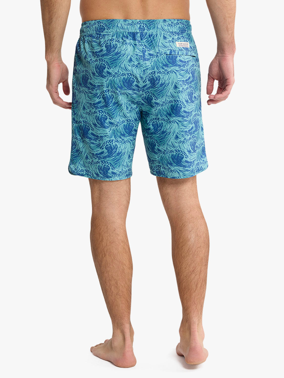 Men's swim trunks with blue and turquoise wave pattern throughout the fabric.