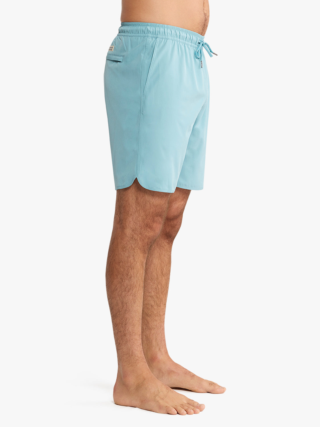 Man wearing bay blue swim trunks with drawstring waist and side pocket detail.
