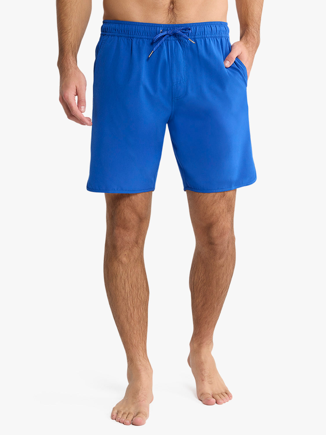 Man wearing cobalt blue shorts with drawstring waistband and side pockets.