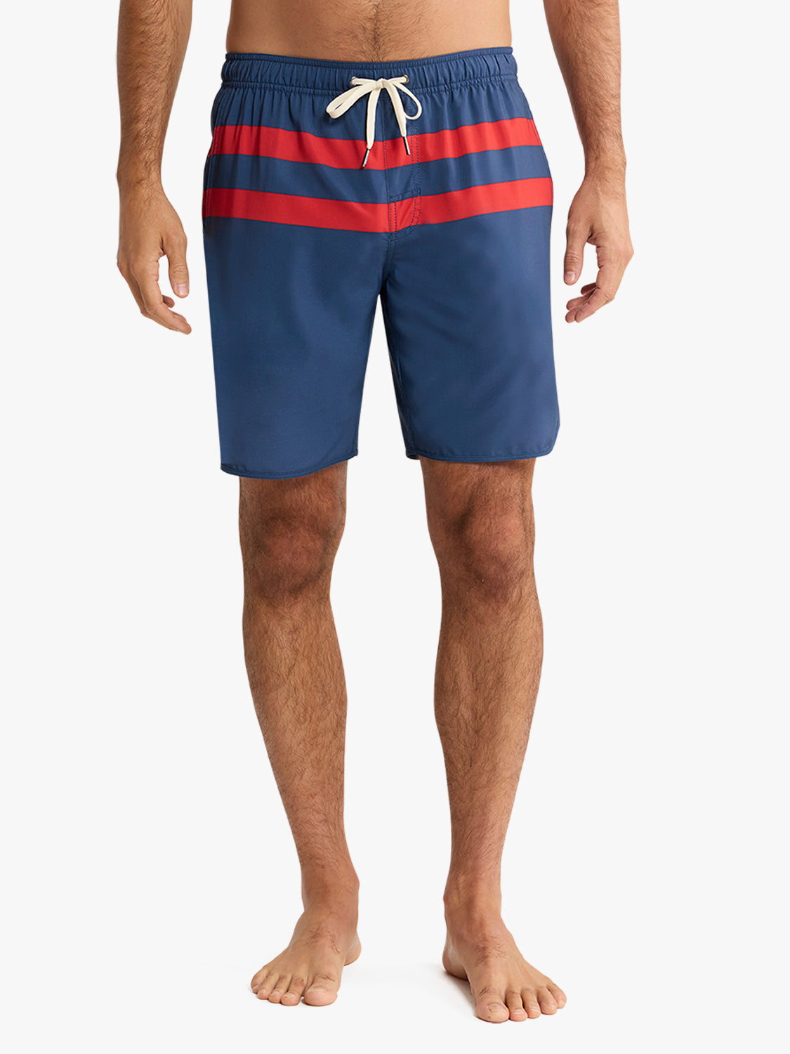 Navy and red striped swim trunks with a white drawstring waistband on a man.