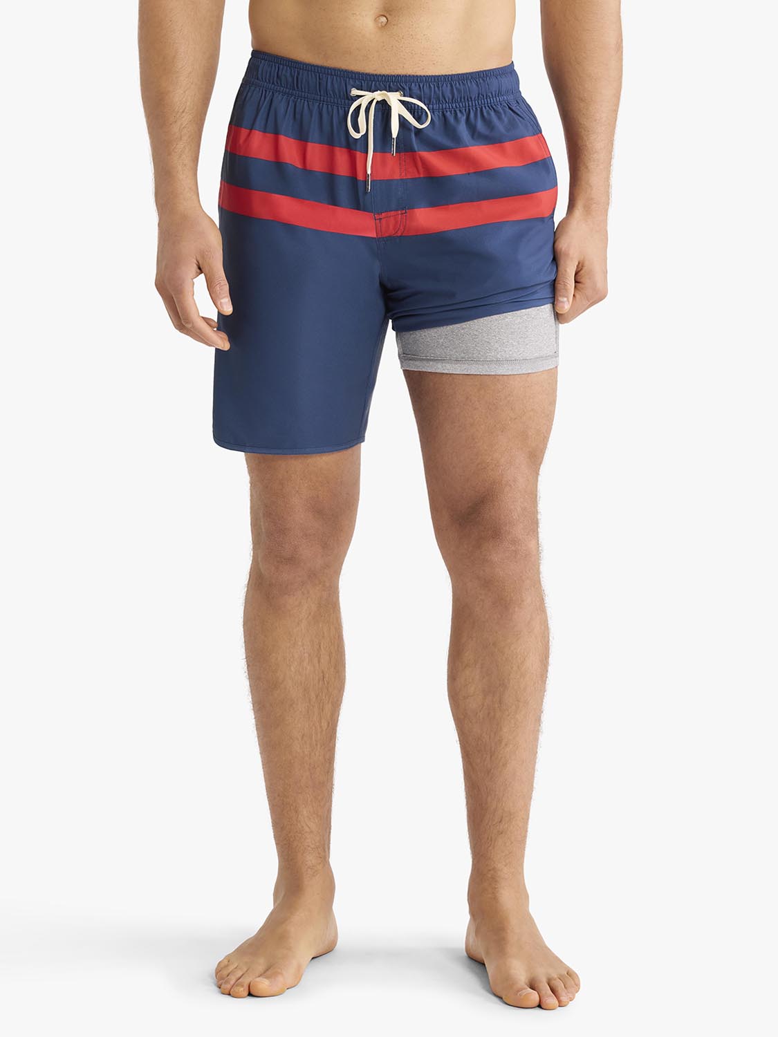 Men's swim trunks with navy base, red horizontal stripes, and gray leg trim.