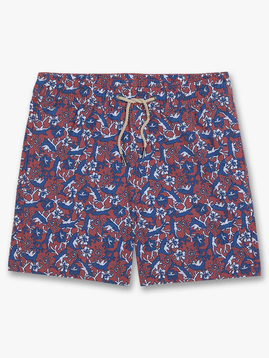 Kids swim trunks with red and blue all-over shark and spiral pattern and drawstring waist.