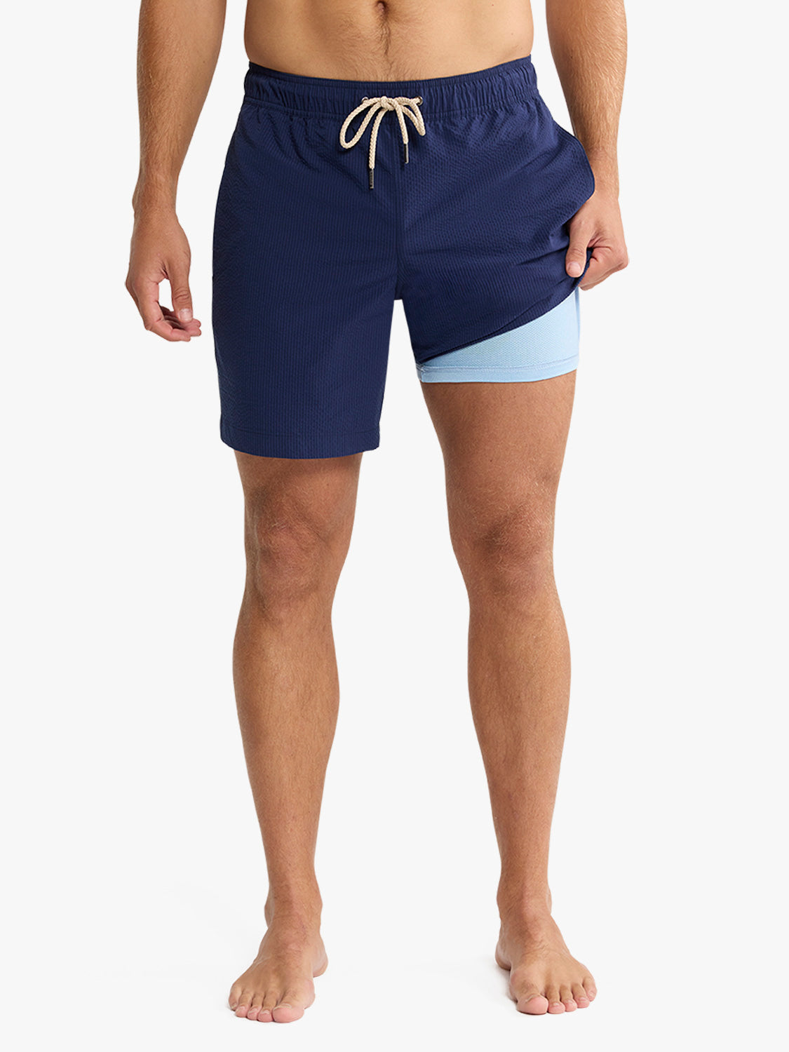 Navy seersucker swim trunk with light blue contrast lining and drawstring waistband.