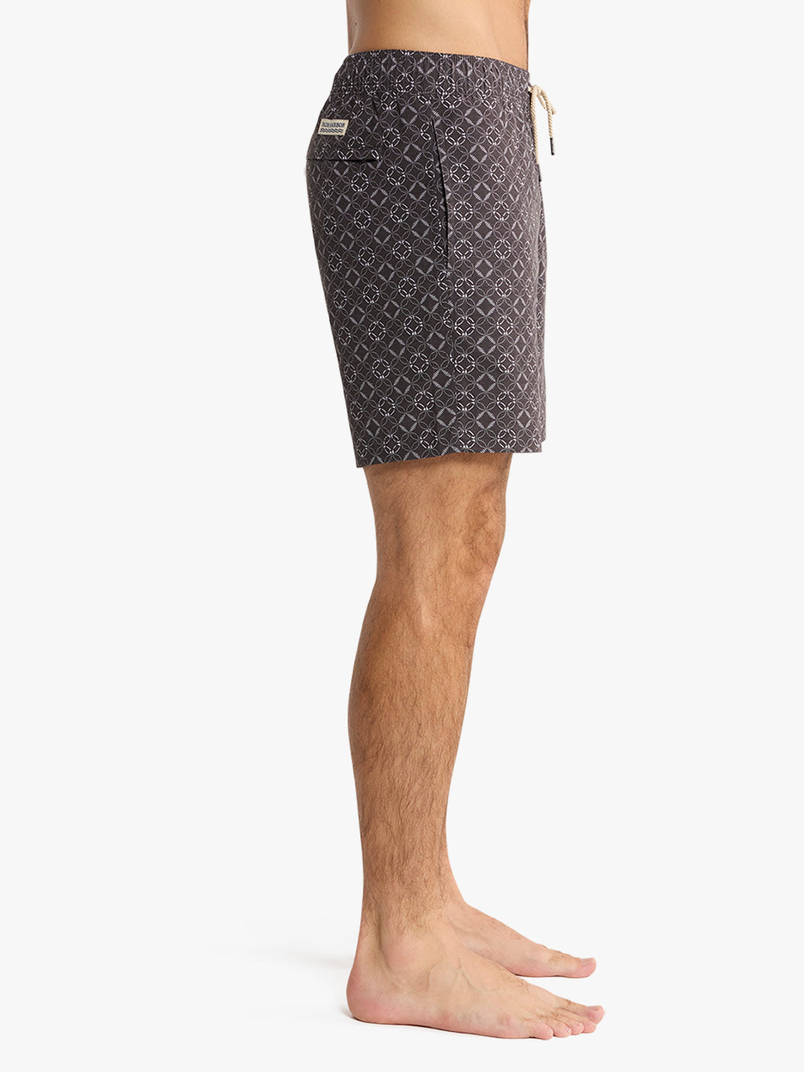 Men's dark gray swim trunk with all-over geometric circle and diamond pattern and drawstring waist.