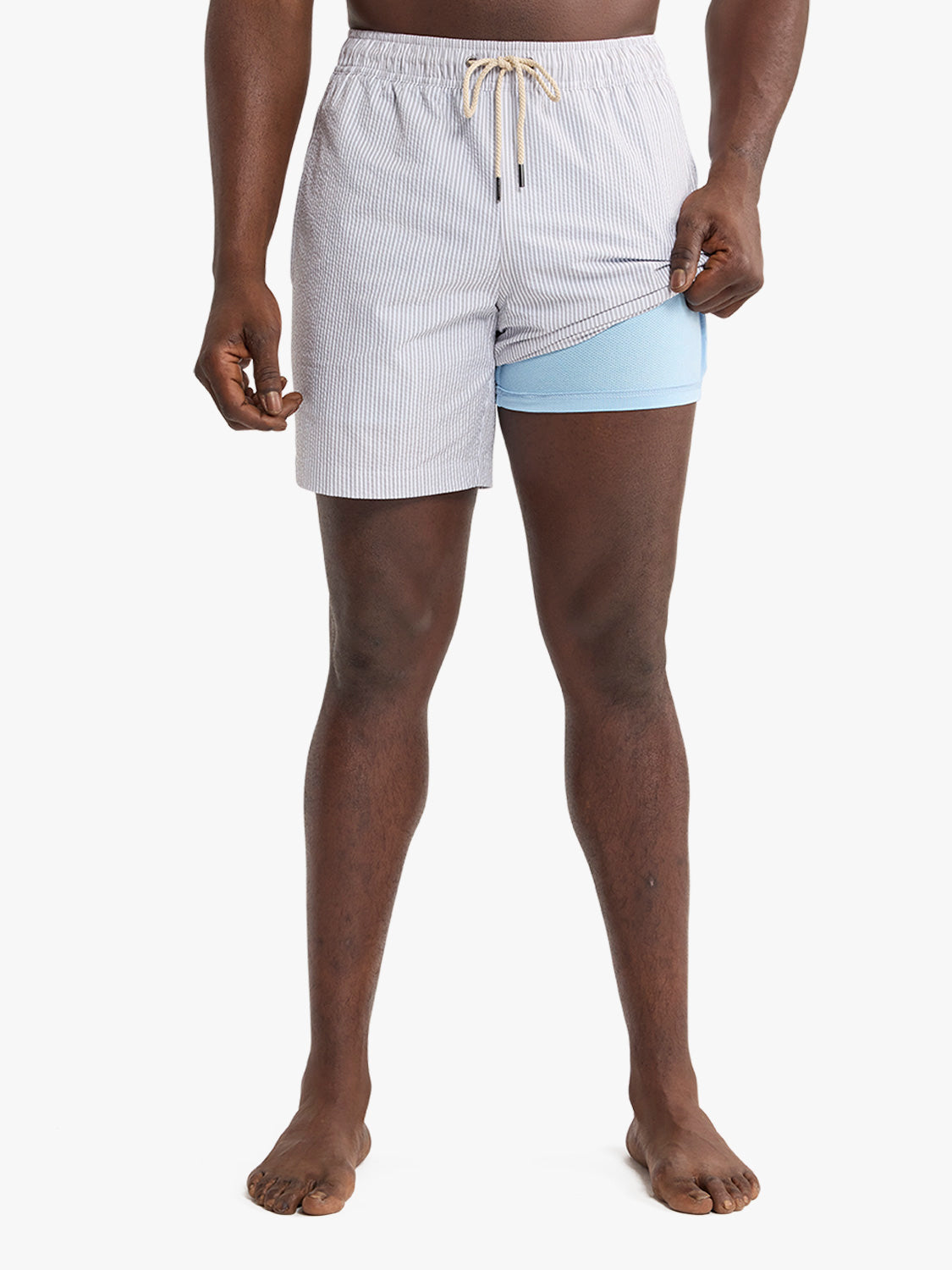 Grey seersucker swim trunk with light blue mesh liner and drawstring waistband displayed on model.
