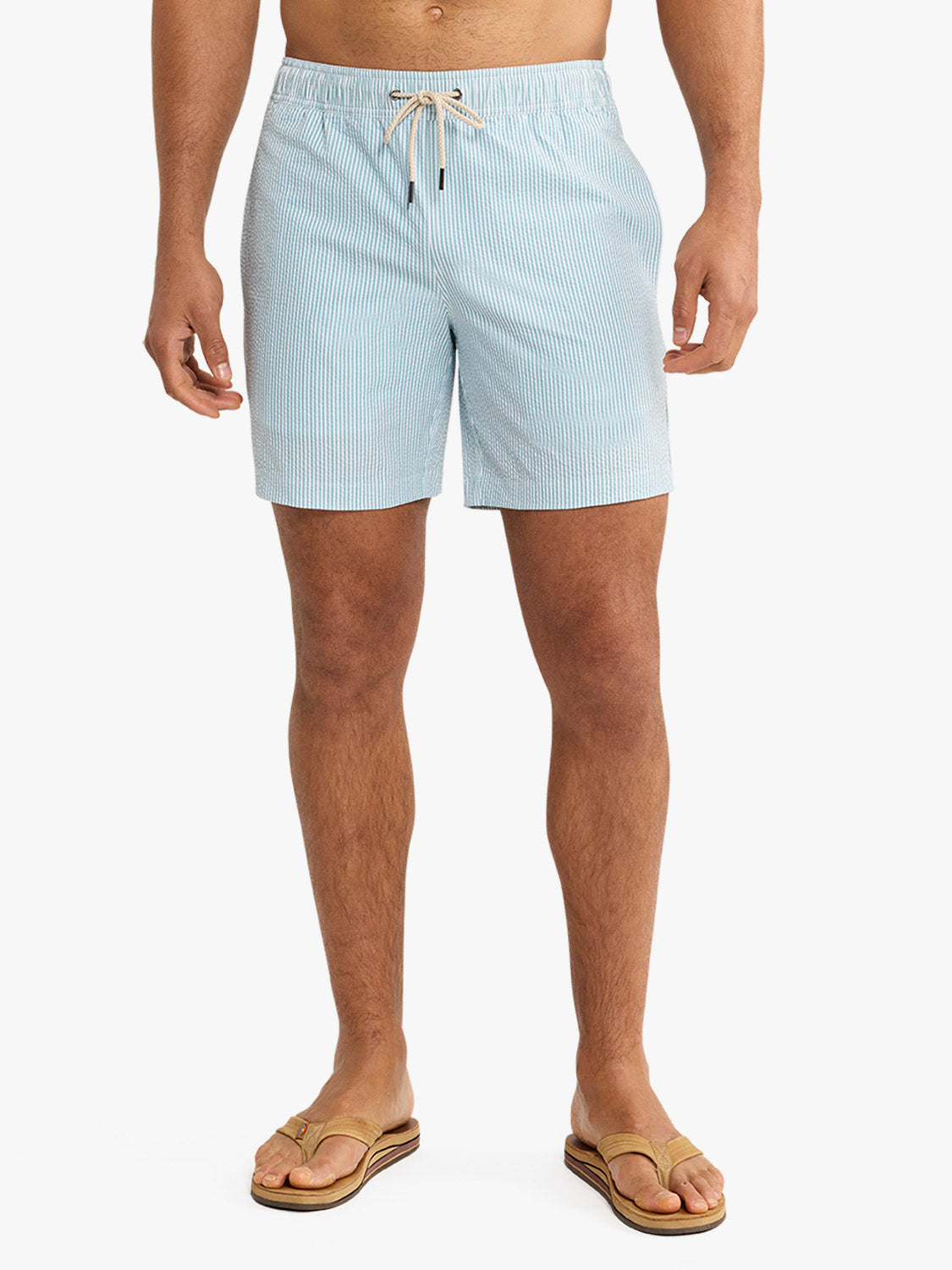 Men's light blue seersucker swim trunk with vertical stripes and drawstring waistband.