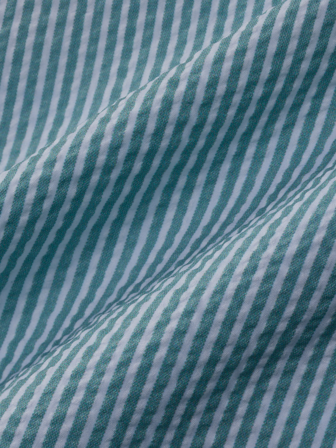 Seapine and white vertical striped seersucker fabric with textured weave and visible stitching detail.