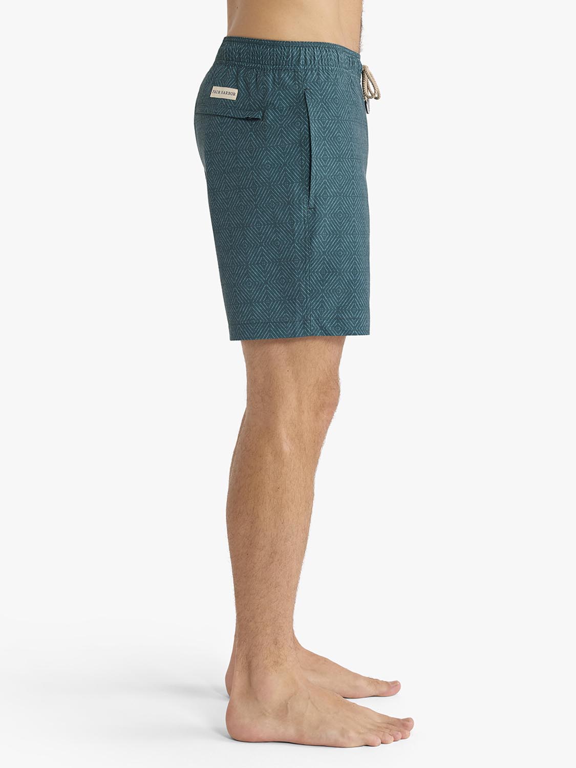 Green shibori patterned swim trunk with drawstring waist and small label detail.