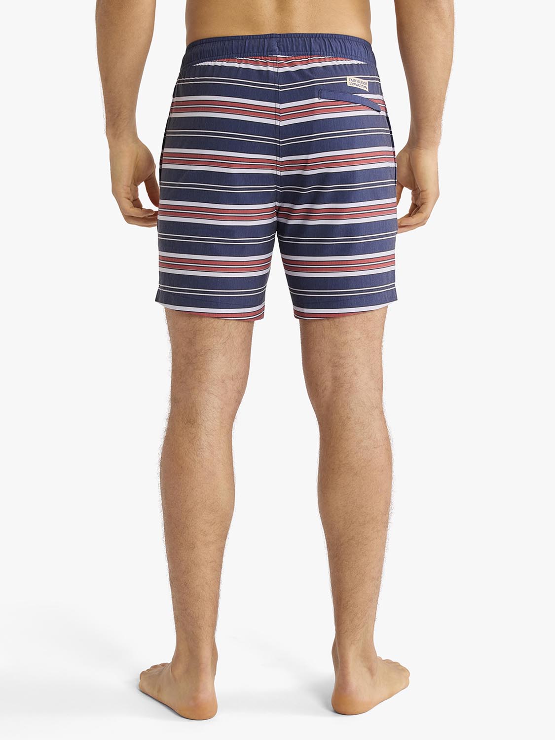 Man wearing navy, red, and white horizontal striped swim trunks with elastic waistband, shown from behind.