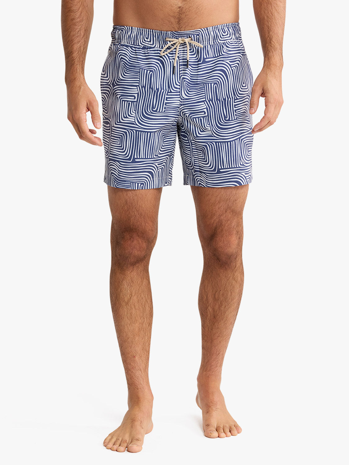 Men's navy swim trunks with white wavy stripe pattern and drawstring waistband.