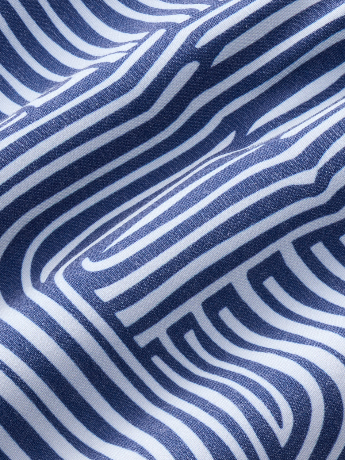 Navy fabric with white and gray wavy striped pattern and textured weave surface.