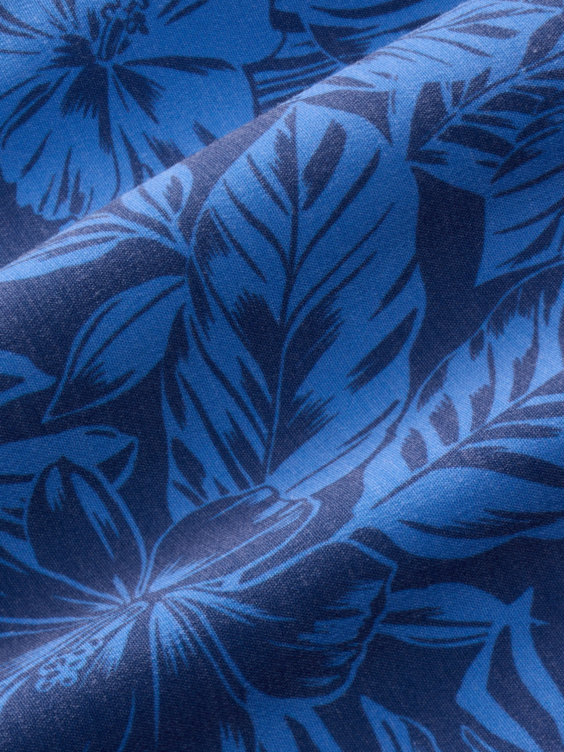 Fabric trunk featuring a botanical leaf pattern in shades of blue.