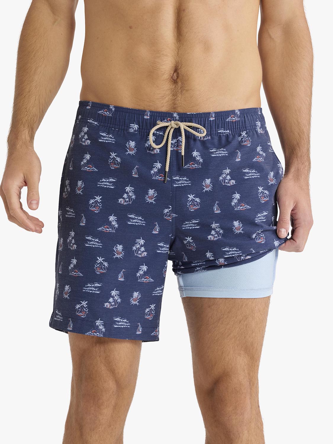 Navy swim trunks with white nautical pattern and light blue mesh liner displayed on model.