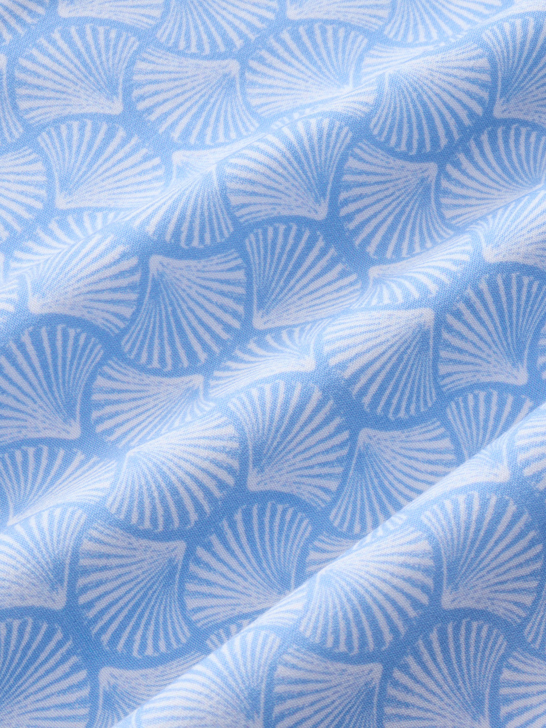 Sky blue fabric with an all-over shell pattern featuring radiating line details throughout.