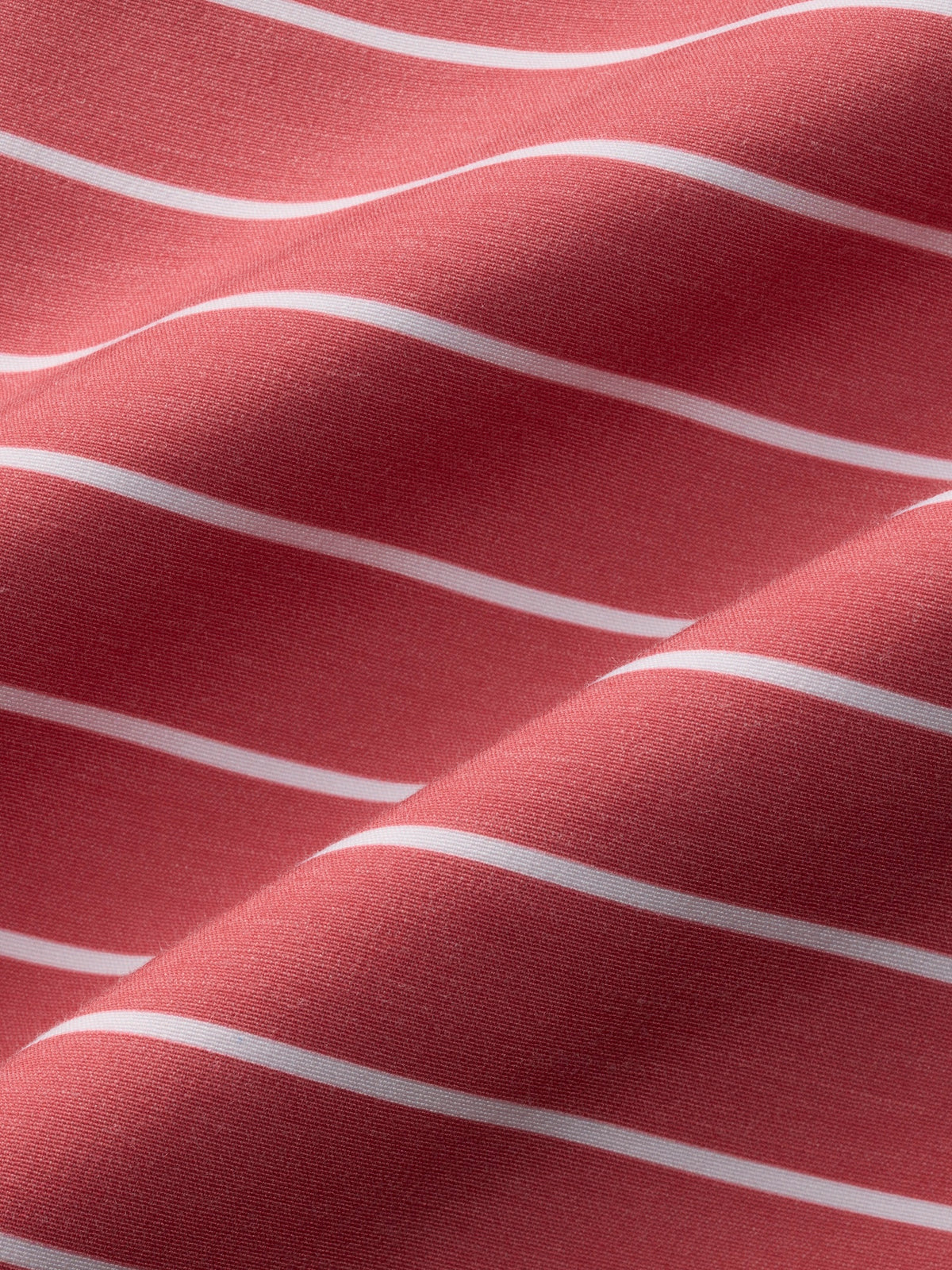 Red and white striped swim trunk fabric with textured ribbed material and horizontal wave pattern details.
