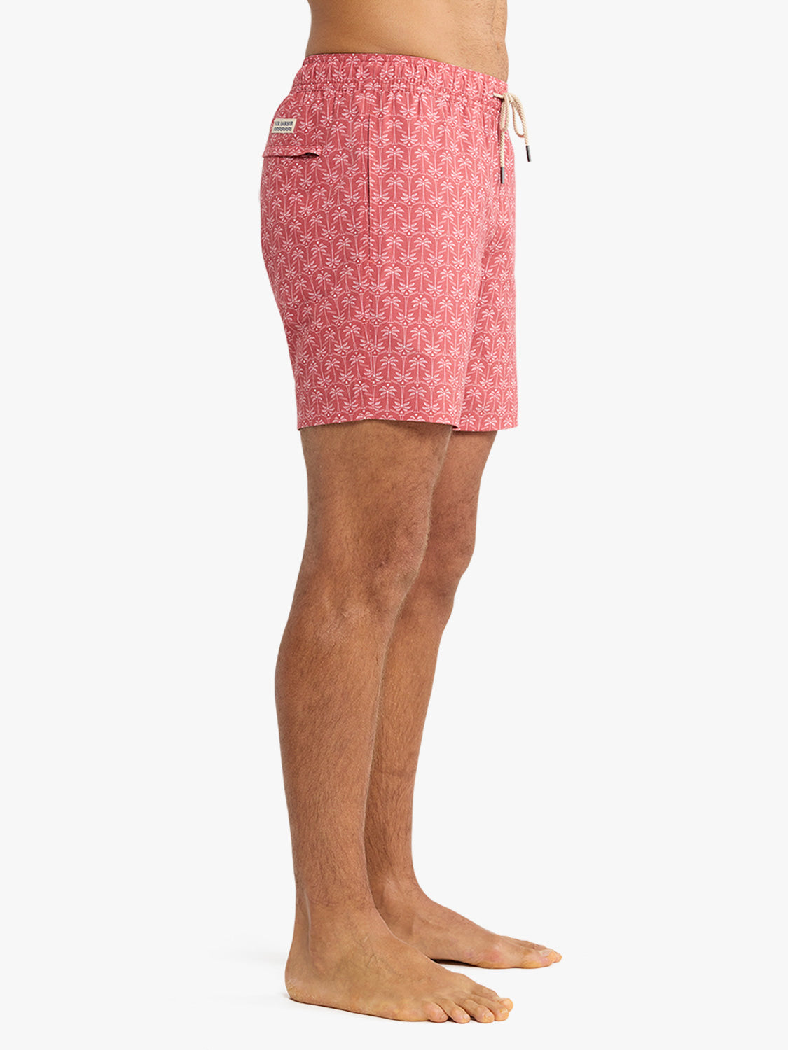 Red patterned swim trunk with drawstring waist and side pocket detail on model.