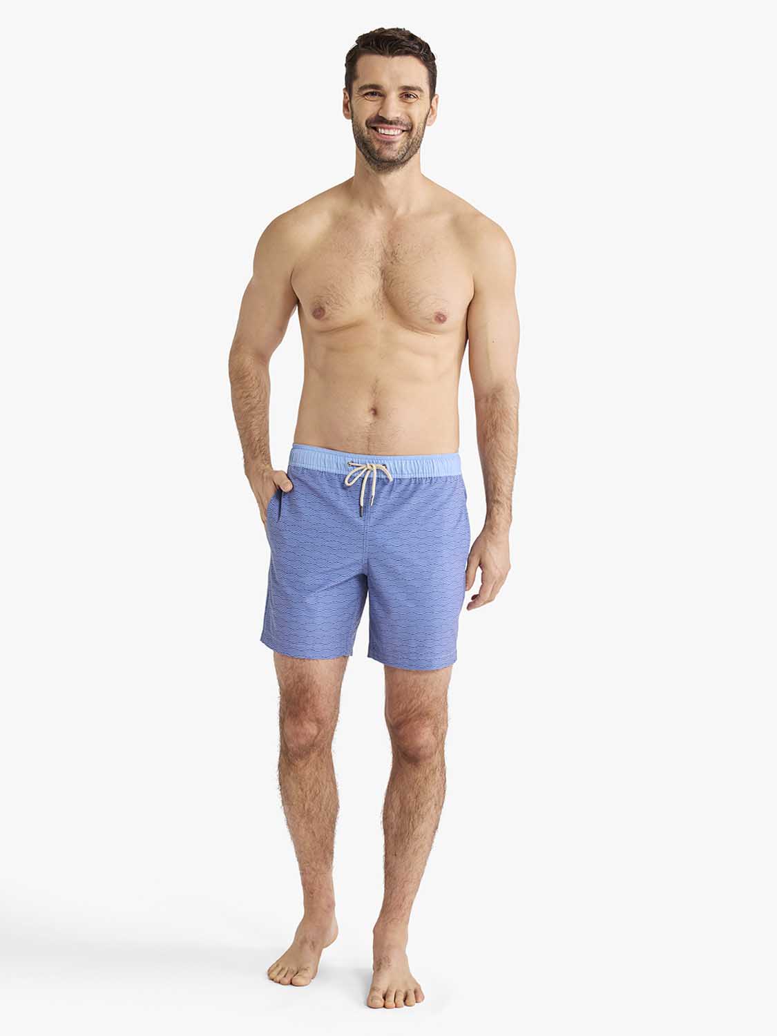 Man wearing blue textured swim shorts with white drawstring tie and side pockets.