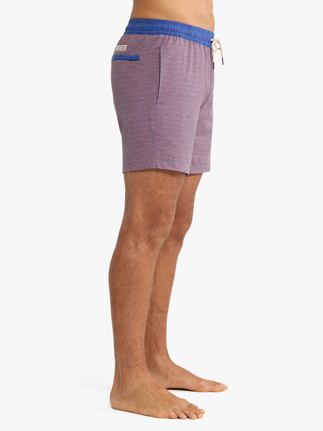 Men's swim trunks with red and blue wave pattern, blue waistband, and drawstring closure.