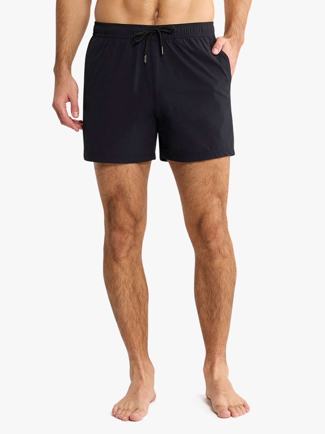 Black swim shorts with drawstring waistband and side pockets on a man.