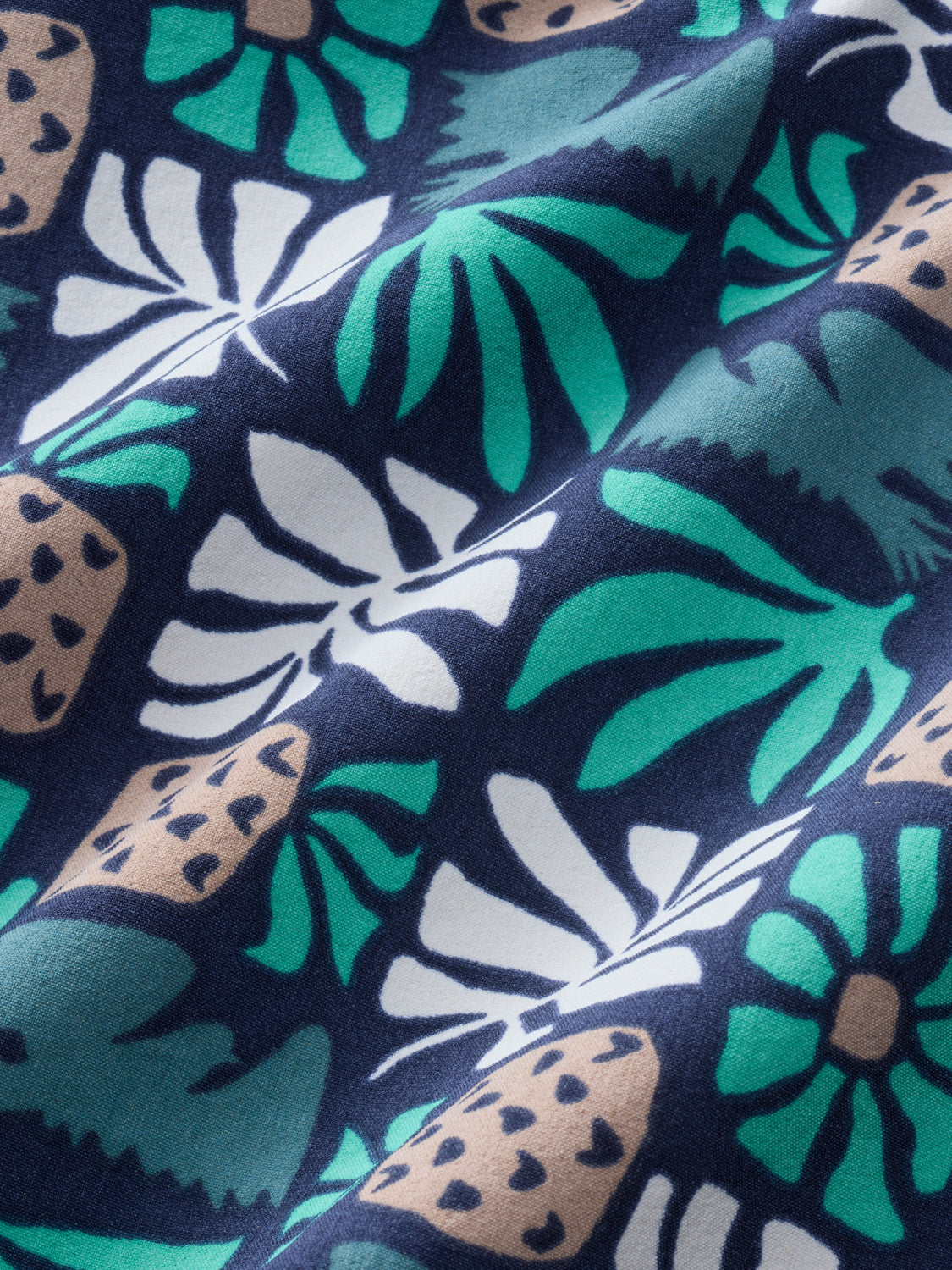 Navy fabric with turquoise, white, and tan palm leaf and floral tile pattern throughout.