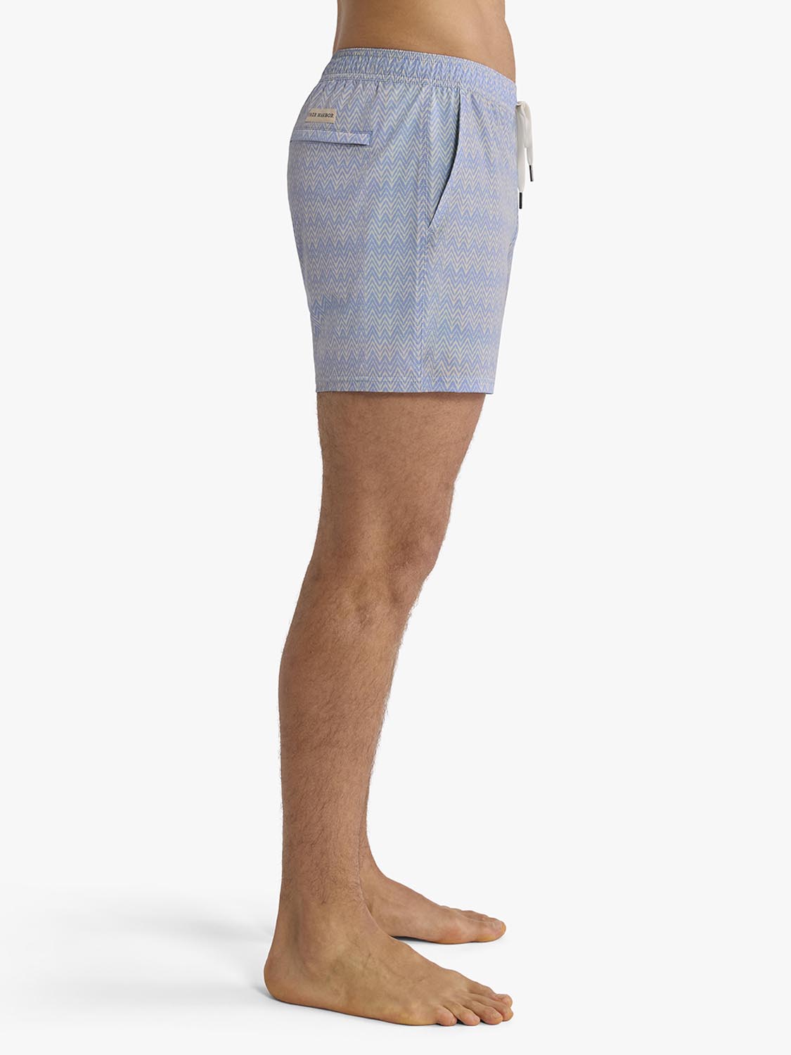 Light blue textured swim trunk with drawstring waistband displayed on male model from waist down.