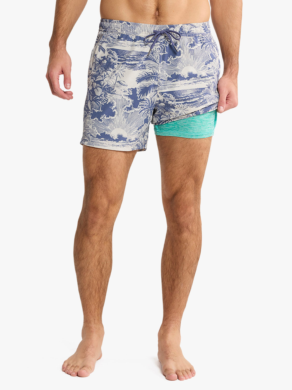 Men's swim trunks featuring navy and cream palm print with turquoise liner shorts visible.