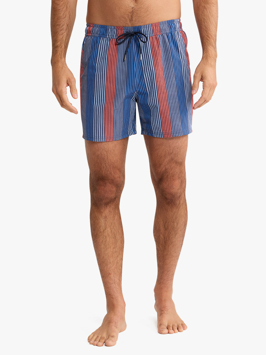 Man wearing blue swim trunks with vertical red and white stripes and drawstring waist.