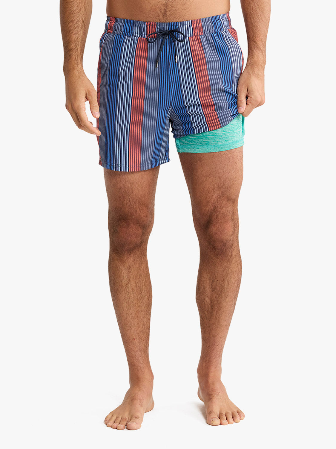 Man wearing blue striped swim trunk with red vertical stripes and turquoise mesh lining detail.