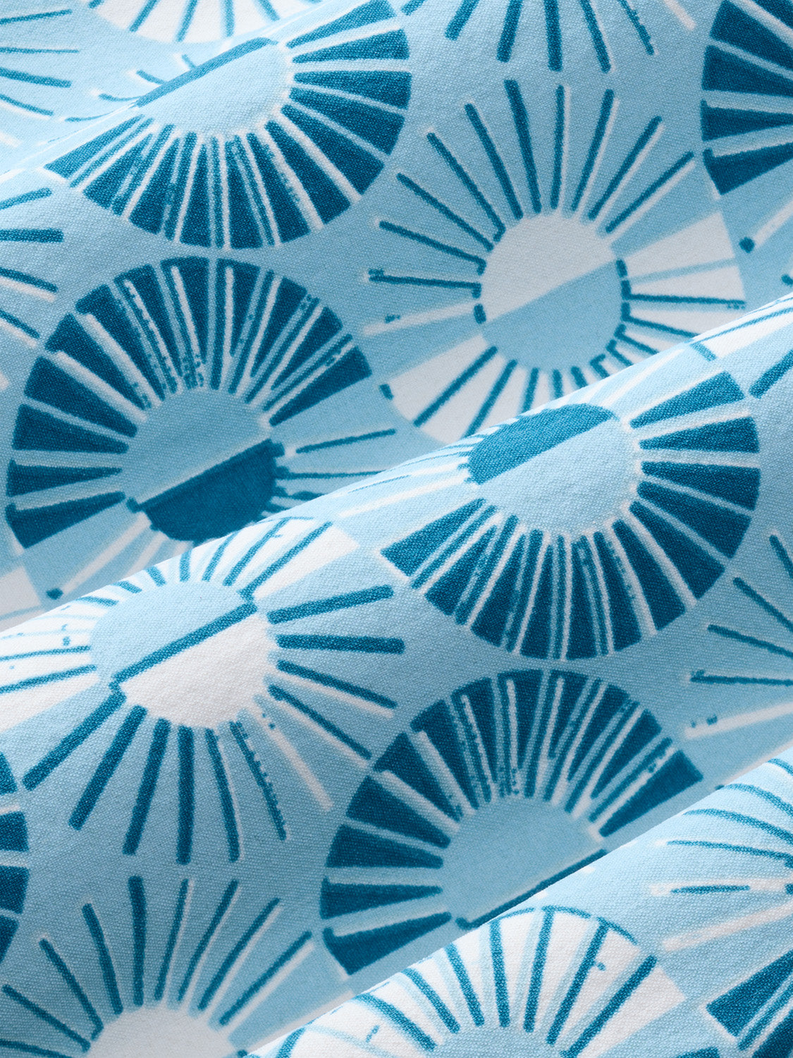 Bay blue fabric features a geometric sunburst pattern in varying shades of teal and white.