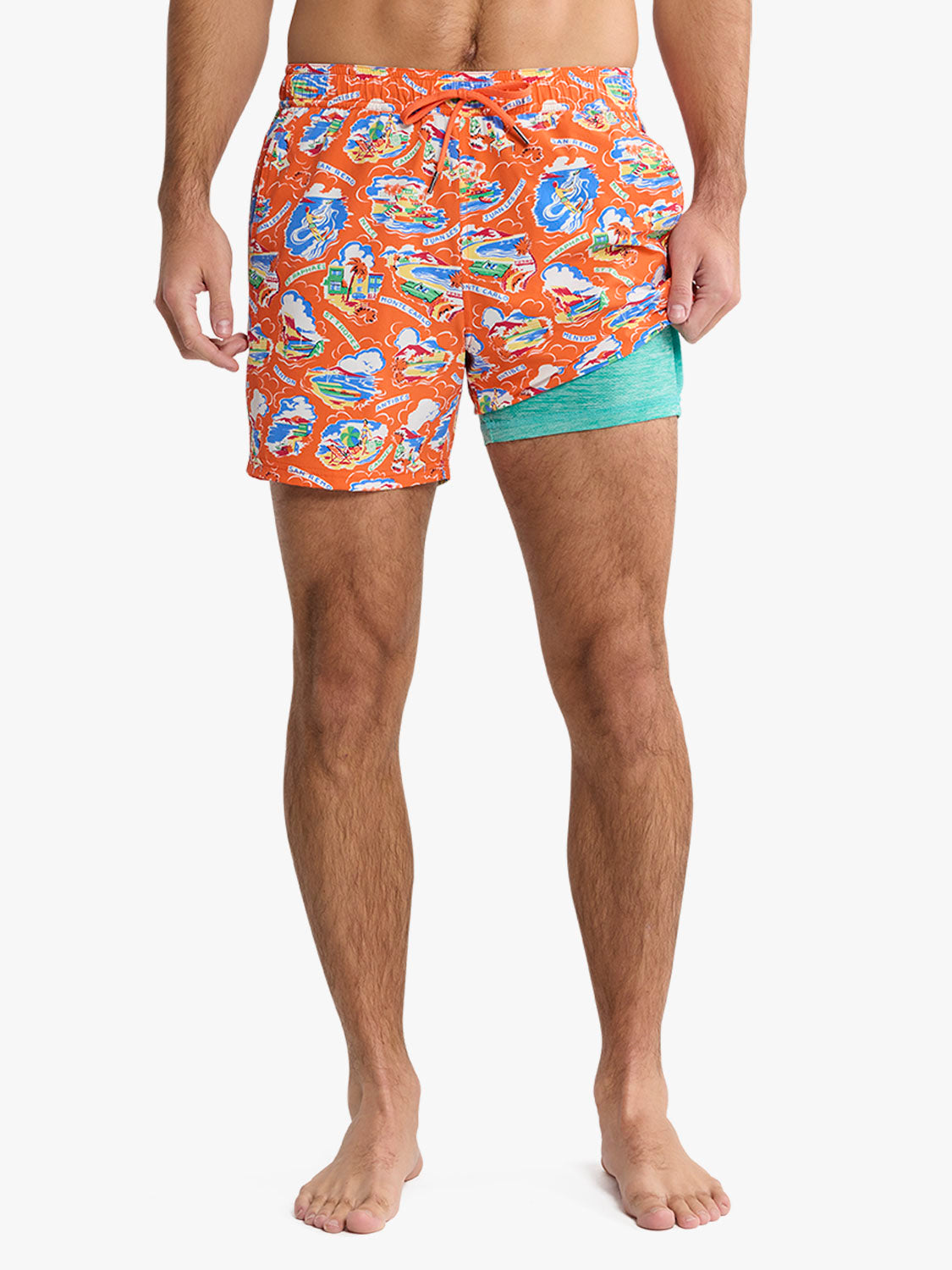 Man wearing orange swim trunks with blue and white boat pattern and turquoise underside.