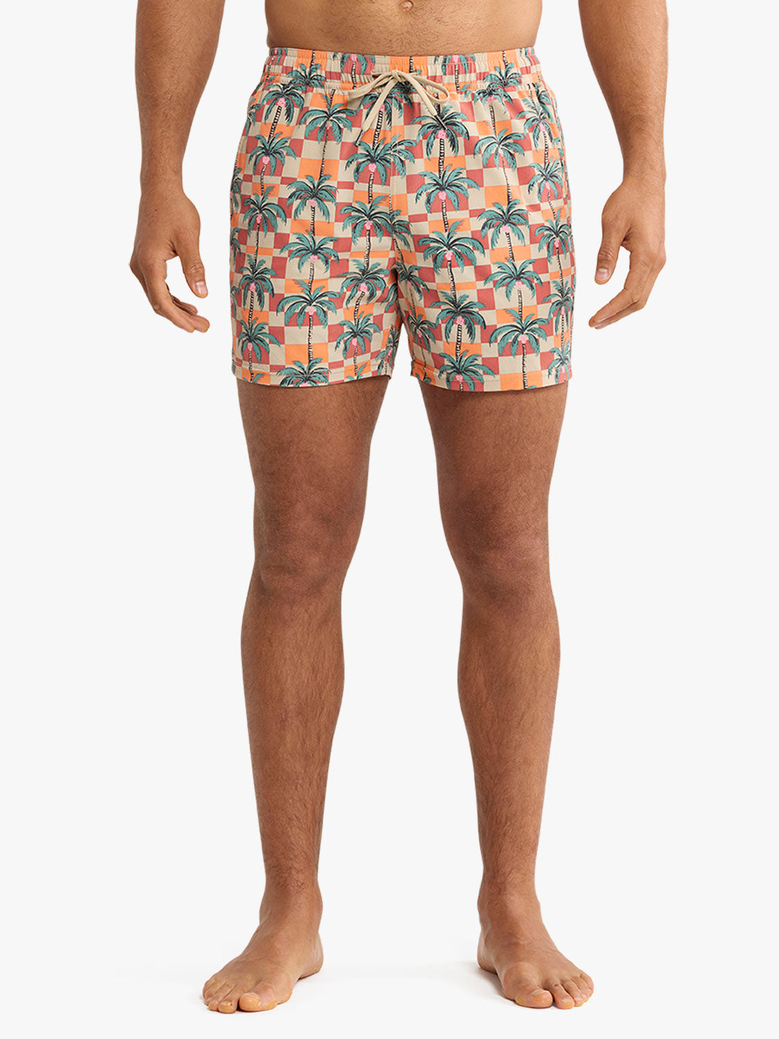 Men's swim trunk with checkered pattern in coral and cream featuring black palm trees throughout.