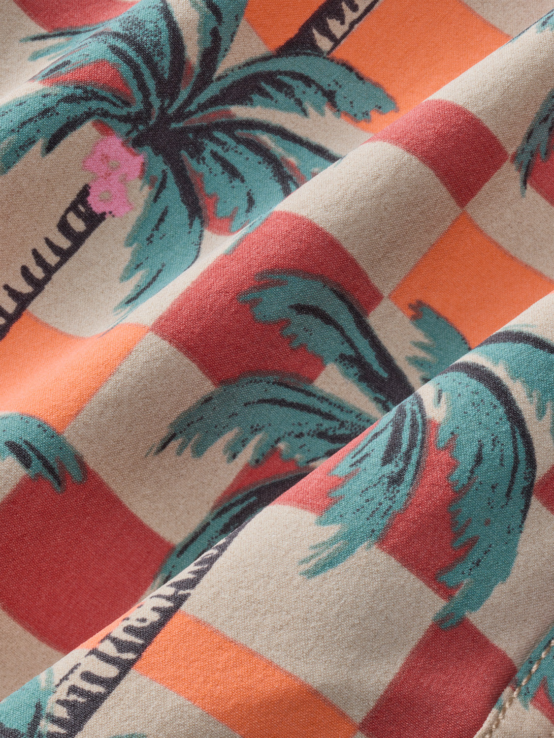 Checkered fabric with alternating squares featuring teal palm trees and text on coral, cream, and burgundy backgrounds.