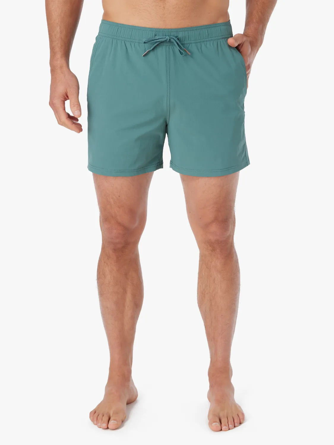 Person wearing solid seapine green bungalow trunk with drawstring on a white background. 