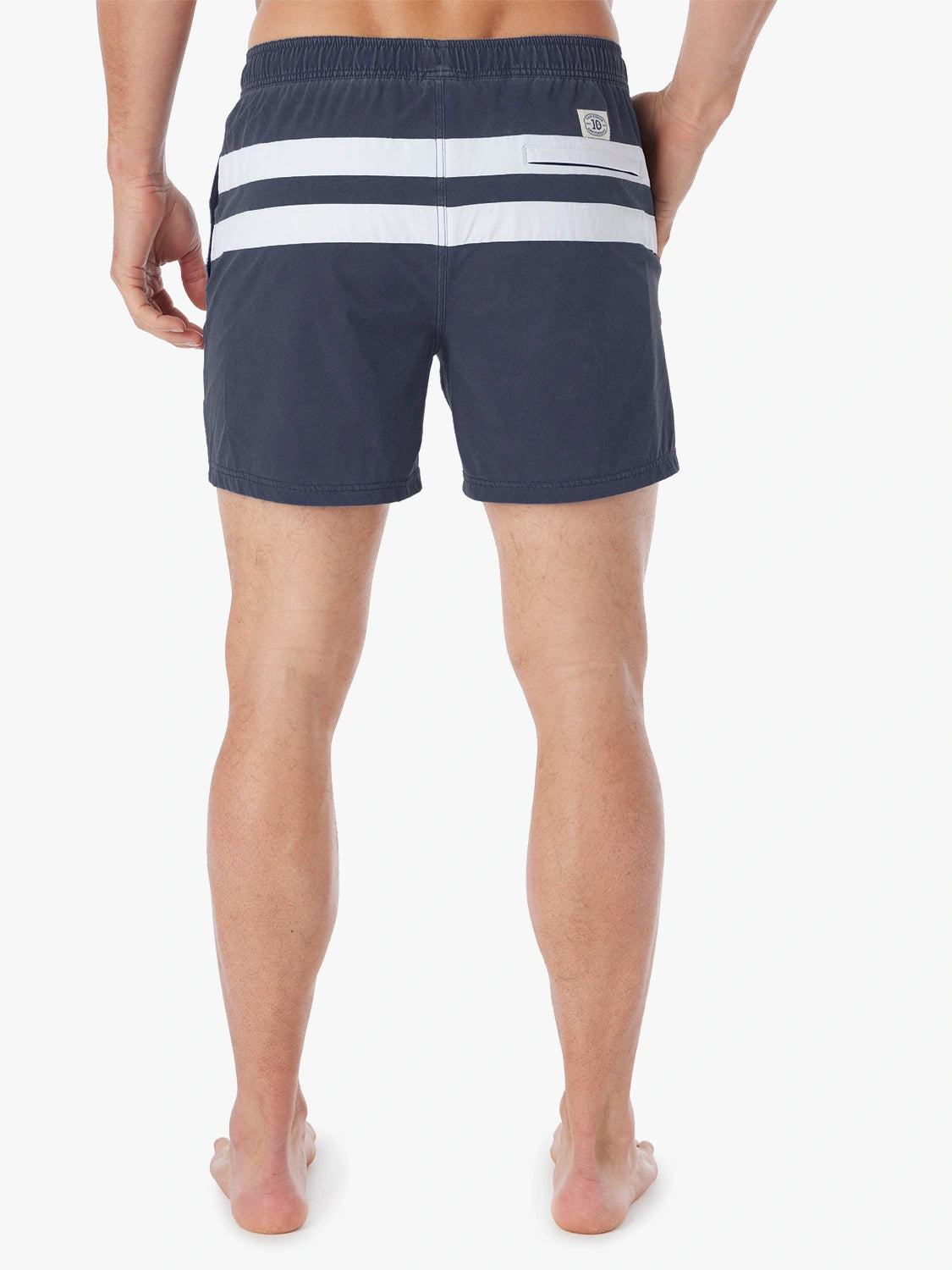Navy swim trunk with white horizontal stripes and an elastic waistband viewed from the back.