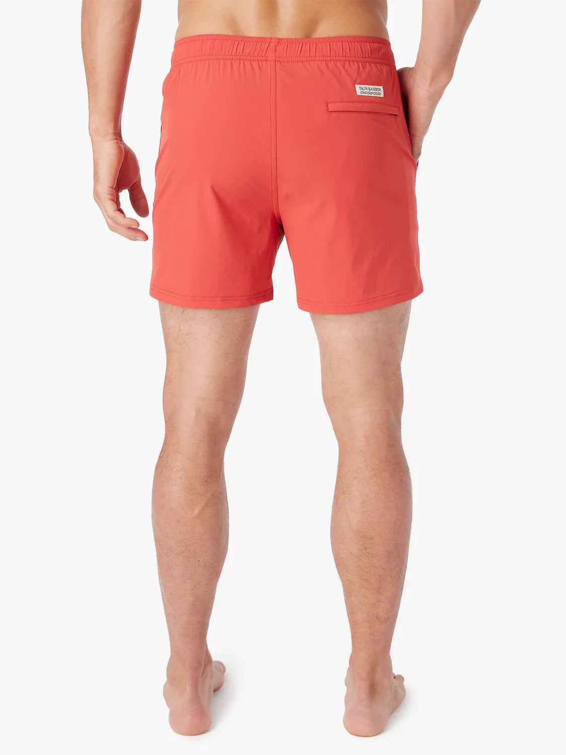 Person wearing solid red bungalow trunk  on a white background. Showing the back view. 