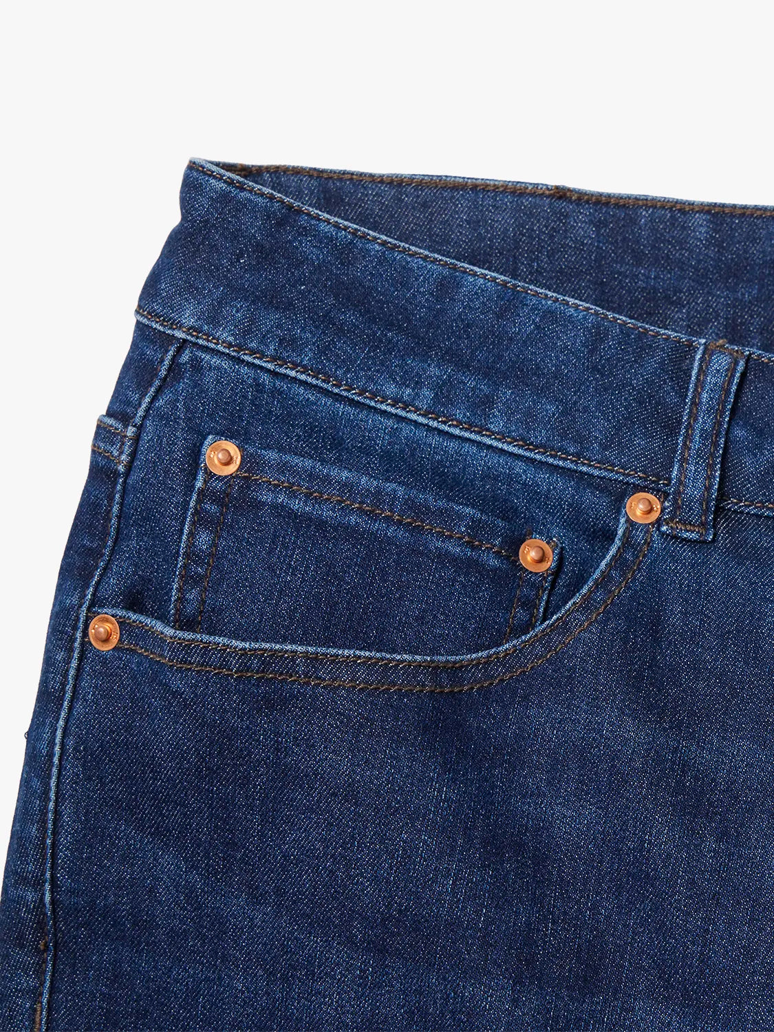 Detail image of the waist band and pocket design of pair of blue denim pants. 