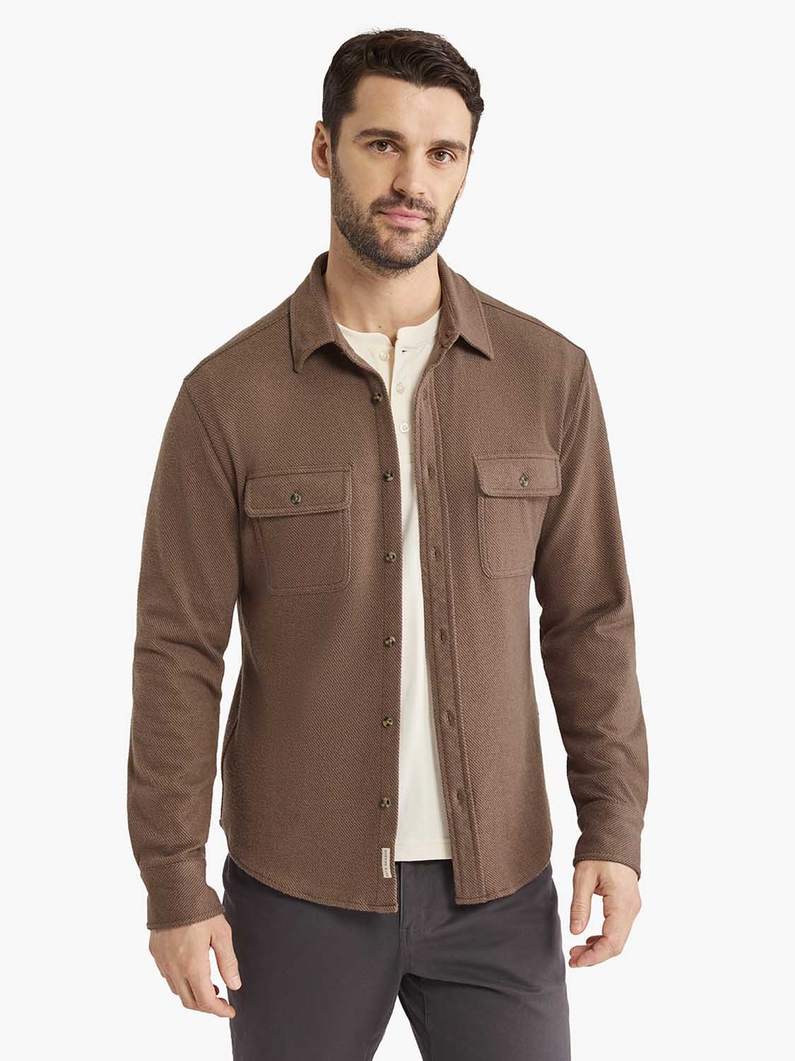 Man wearing a brown espresso twill flannel shirt with chest pockets over a cream-colored undershirt.