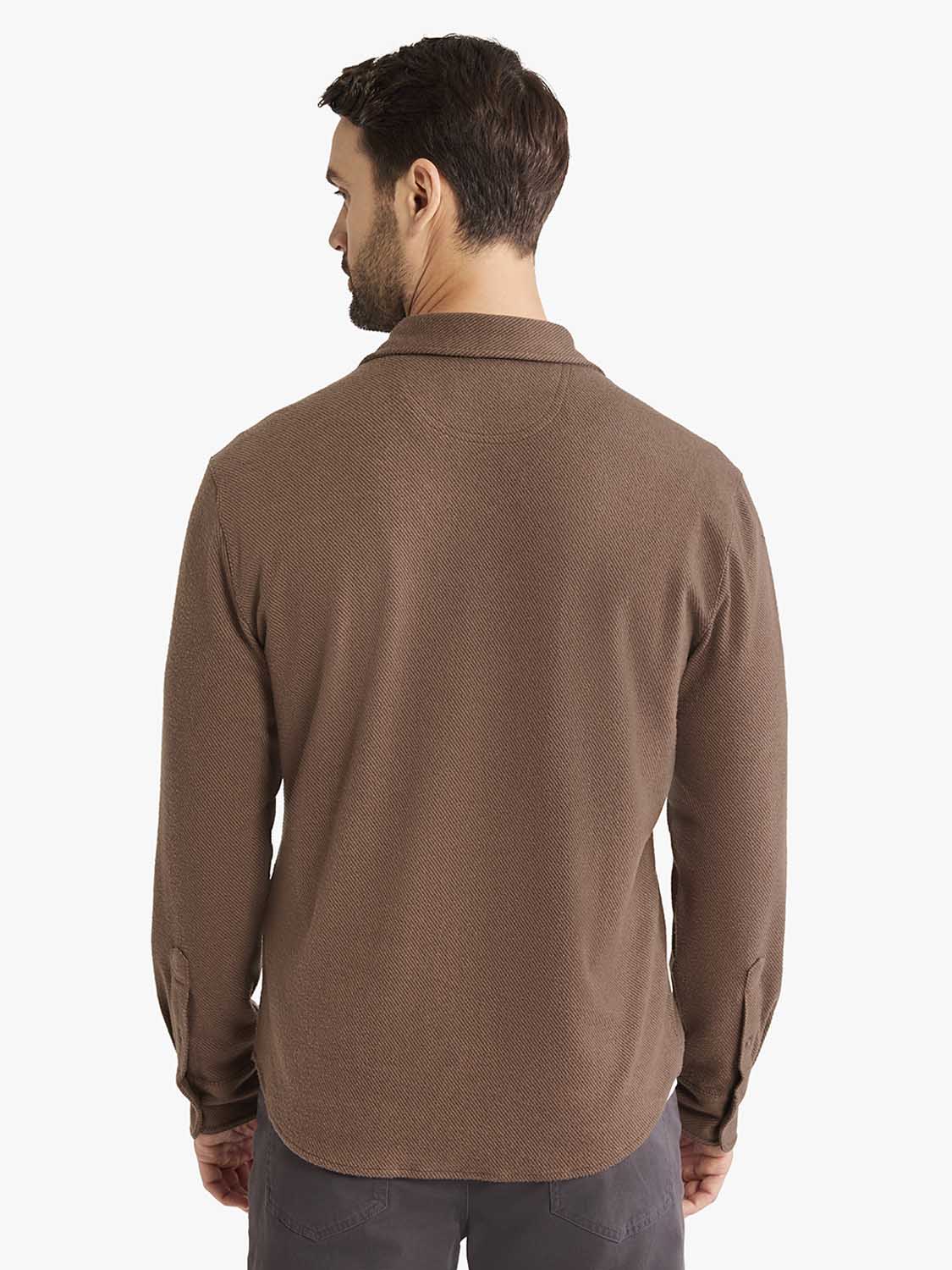 Man wearing a brown espresso twill flannel shirt with long sleeves and a collar, shown from the back.