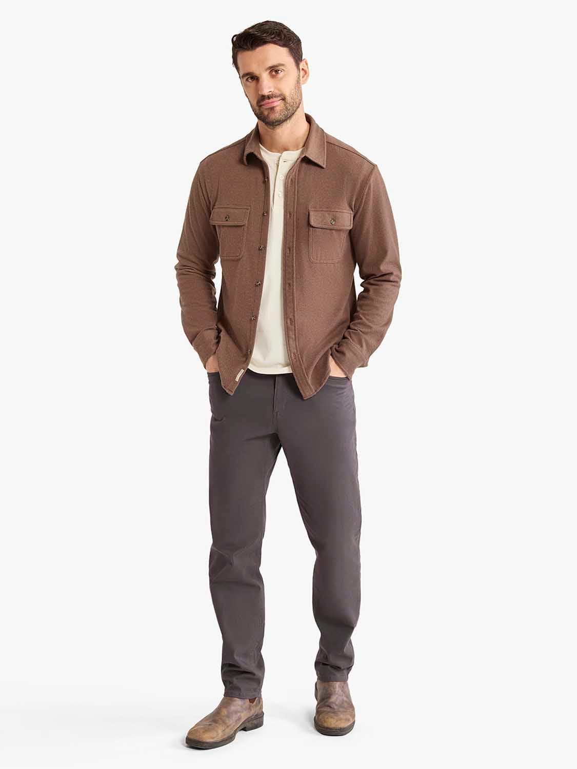 Man wearing a brown espresso twill flannel shirt with chest pockets over a cream undershirt.