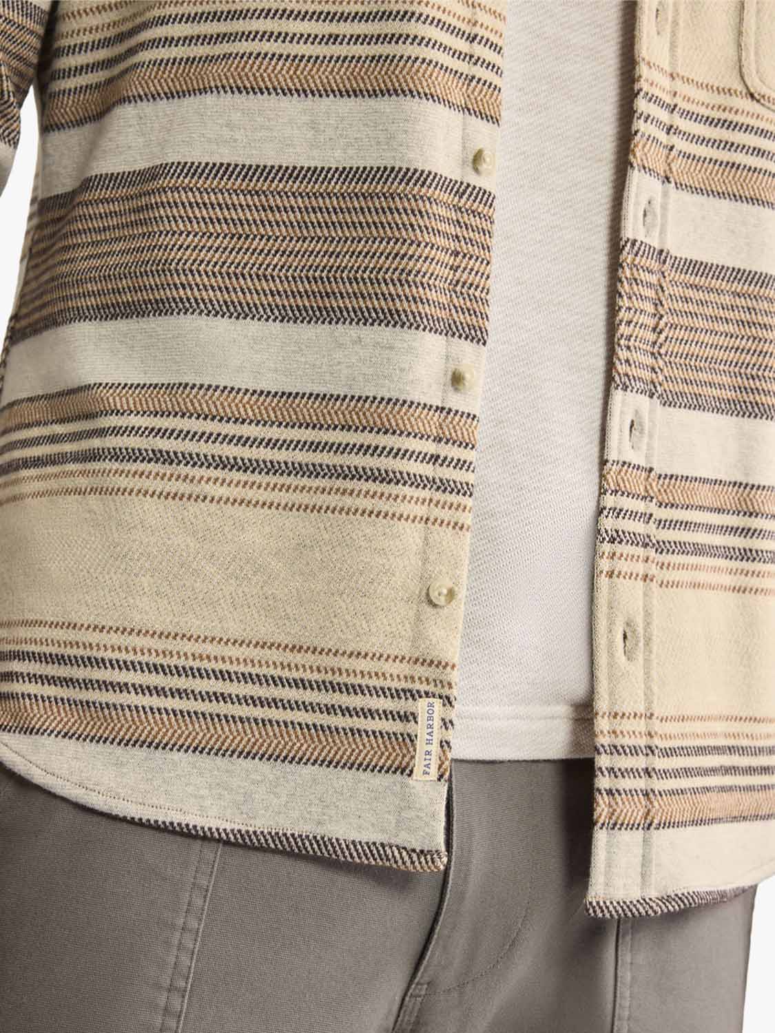 Beige and brown striped flannel shirt with horizontal bands and cream-colored button front closure.