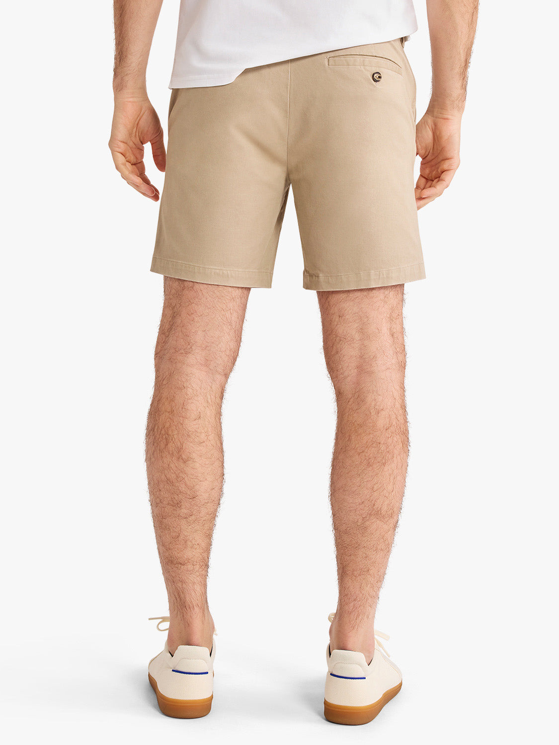 Man wearing khaki Horizon shorts with a white shirt and cream canvas shoes.