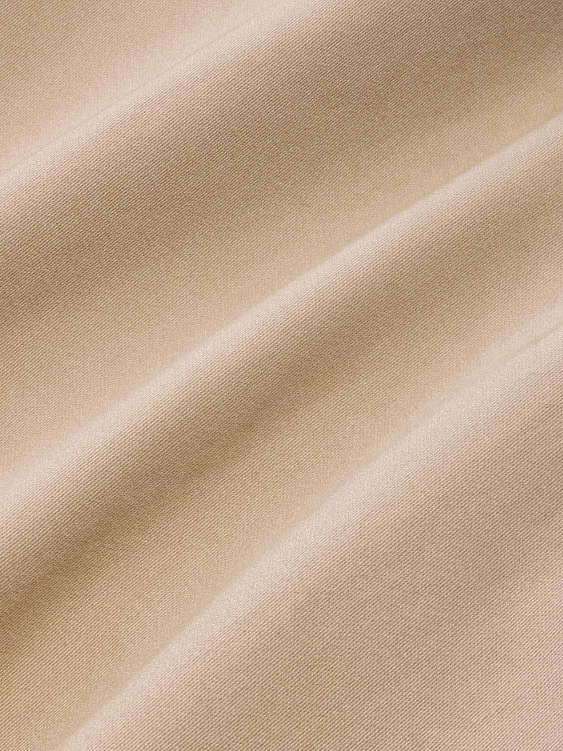 Khaki-colored fabric with diagonal ribbed texture and subtle light reflections across the surface.
