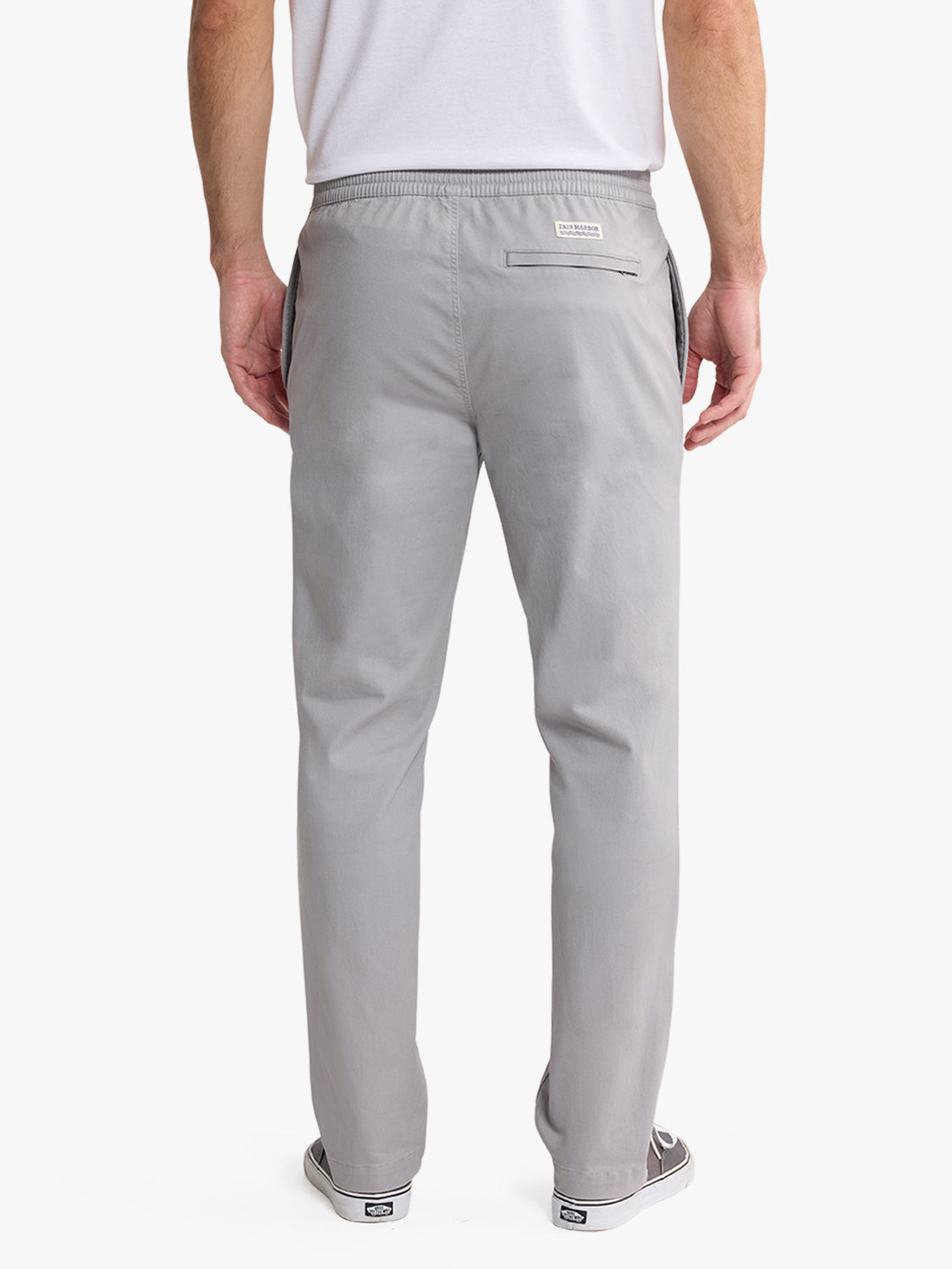 Man wearing light gray pull-on pants with elastic waistband and back pocket, shown from behind.